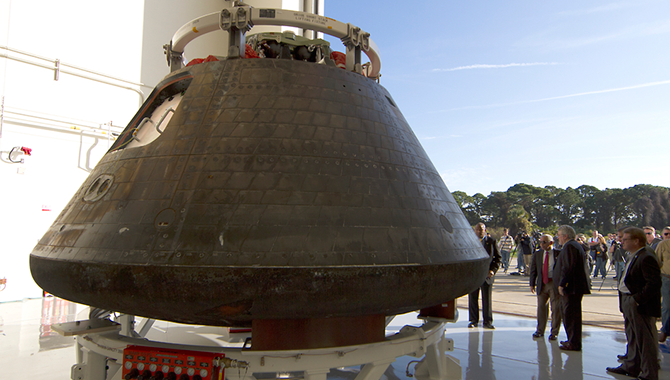 NASA Administrator Charles Bolden surveys the Orion crew capsule, recently returned to Kennedy Space Center following its successful maiden flight. Photo Credit: NASA/Cory Huston