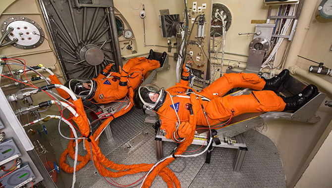 The spacesuit, known as the Modified Advanced Crew Escape Suit, that crew will wear during Orion deep space missions is tested at Johnson Space Center. Photo Credit: NASA/Bill Stafford