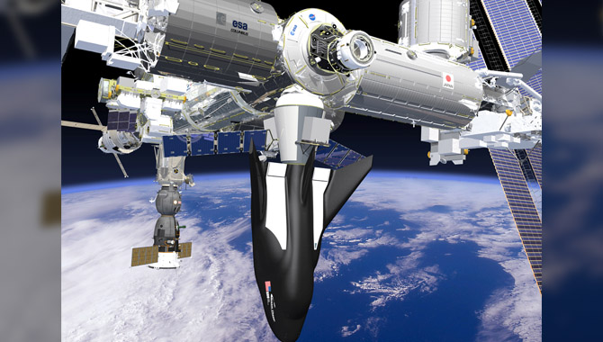 Sierra Nevada Corporation’s Dream Chaser spacecraft and cargo module, shown here attached to the ISS, will begin transporting cargo to and from the space station as early as 2019. Image Credit: Sierra Nevada Corporation