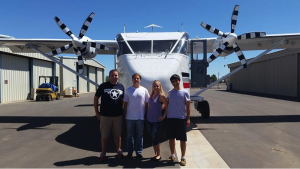 Jeremiah Mcnatt, Justin Niehaus, Amanda Stevenson, Jeff Chin. Description: Chin with three GRC Rocket University team members: Jeremiah McNatt, Justin Niehaus, and Amanda Stevenson. Photo Credit: Airborne Systems/Bill Gargano