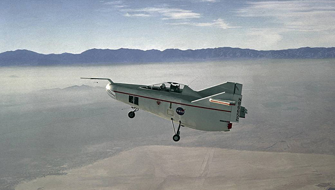 The M2-F1, NASA’s “flying bathtub,” being pulled behind a C-47 tow plane high above Rogers Dry Lake. Photo Credit: NASA