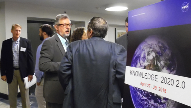 April 2015, Dan Ranta (far left), former Director of Knowledge Sharing, ConocoPhillips; and Jean-Claude Monney (center), Global Knowledge Management Lead, Microsoft Services, mingle with participants at the welcome reception of Knowledge 2020 2.0. Photo Credit: NASA