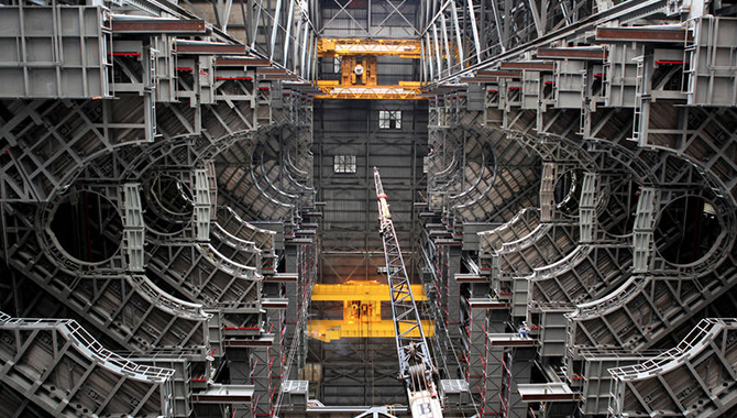 High up in the Vehicle Assembly Building at NASA's Kennedy Space Center in Florida, an overhead crane lowers the final work platform, A north, into place for installation in High Bay 3 In January 2017. Installation of the final topmost level completed the 10 levels of work platforms that will surround NASA's SLS rocket and the Orion spacecraft and allow access during GSDO processing for missions. Photo credit: NASA/Frank Michaux