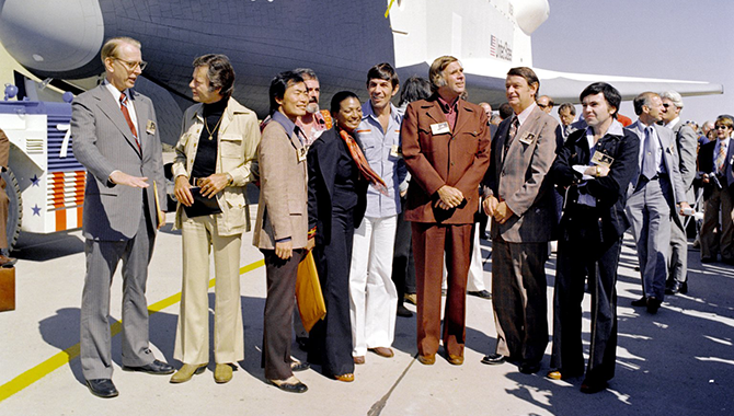 Members of the cast and creator of the popular TV show Star Trek attending the rollout of the space shuttle prototype Enterprise at Air Force Plant 42 in Palmdale in 1976. From left, NASA administrator James Fletcher, DeForest Kelly, George Takei, Nichelle Nichols, Leonard Nimoy, Gene Rodenberry and Walter Koenig. Photo Credit: NASA