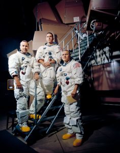 13 Nov. 1968–These three astronauts are the prime crew of the Apollo 8 lunar orbit mission. Left to right, are James A. Lovell Jr., command module pilot; William A. Anders, lunar module pilot; and Frank Borman, commander. They are standing beside the Apollo Mission Simulator at the Kennedy Space Center (KSC). Credit: NASA