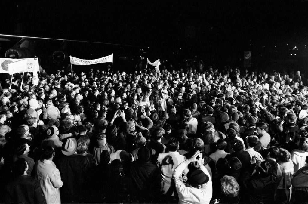 29 Dec. 1968–Although it was past 2 a.m., a crew of more than 2,000 people were on hand at Ellington Air Force Base to welcome the members of the Apollo 8 crew back home. Astronauts Frank Borman, James A. Lovell Jr., and William A. Anders had just flown to Houston from the pacific recovery area by way of Hawaii. The three crewmen of the historic Apollo 8 lunar orbit mission are standing at the microphones in center of picture. Credit: NASA