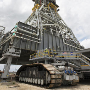 Crawler-transporter 2 (CT-2) is being moved under the mobile launcher May 31, 2018, at NASA's Kennedy Space Center in Florida. Three lifts will be performed to practice lifting procedures, validate interface locations, confirm the weight of the mobile launcher, and develop a baseline for modal analysis. The mobile launcher is equipped with a number of lines, called umbilicals, which will connect to NASA's Space Launch System (SLS) and Orion. CT-2 has been upgraded to handle the weight of the mobile launcher with SLS and Orion atop. Exploration Ground Systems is preparing the ground systems necessary to support the SLS and Orion spacecraft for Exploration Mission-1 and deep space missions. Credit: NASA