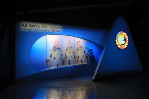 The tribute at the Apollo/Saturn V Center at NASA's Kennedy Space Center opened Jan. 27, 2017, 50 years after the crew was lost. It features numerous items recalling the lives of the three astronauts. It also includes the three-part hatch to the spacecraft itself, the first time any part of the Apollo 1 spacecraft has been displayed publicly. Credit: NASA