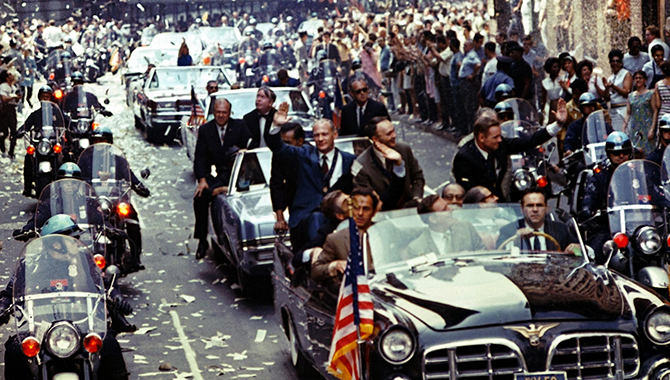 New York City welcomes Apollo 11 crewmen in a showering of ticker tape down Broadway and Park Avenue in a parade termed as the largest in the city's history. Pictured in the lead car, from the right, are astronauts Neil A. Armstrong, commander; Michael Collins, command module pilot; and Edwin E. Aldrin Jr., lunar module pilot. Credit: NASA/Bill Taub