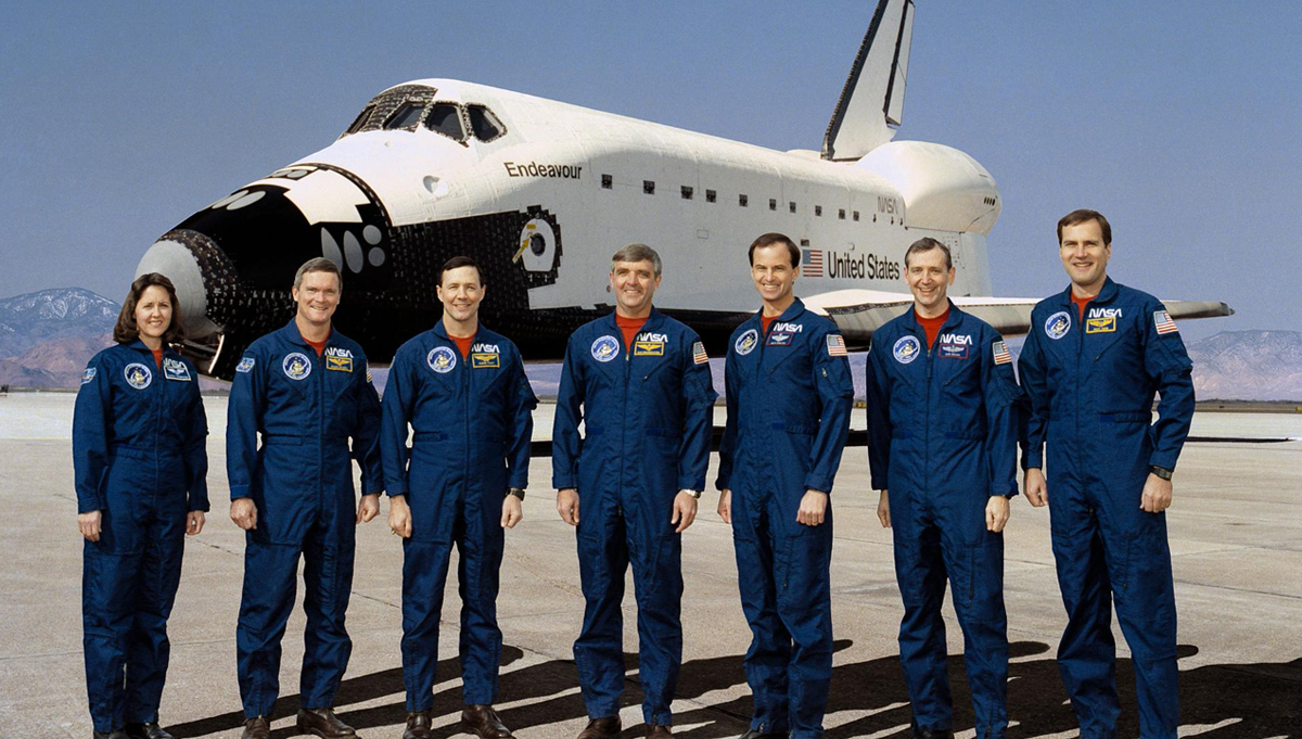 STS-49 crew poses for group portrait. Daniel C. Brandenstein, center, is mission commander; and Kevin P. Chilton, third from right, is pilot. Mission specialists are, left to right, Kathryn C. Thornton, Bruce E. Melnick, Pierre J. Thuot, Thomas D. Akers and Richard J. Hieb. Credit: NASA