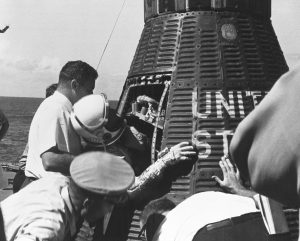 Close-up view of Mercury-Atlas 8 (MA-8) astronaut Walter Schirra Jr. being removed from his Sigma 7 capsule by Navy personnel. Credit: NASA