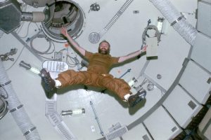 Astronaut Gerald P. Carr demonstrates the effects of zero-gravity as he floats in the forward dome area of the Orbital Workshop of the Skylab space station while in Earth orbit. Credit: NASA