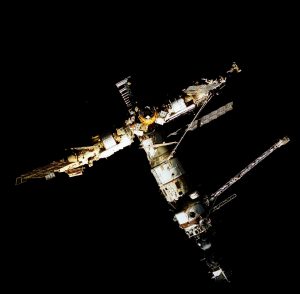 Backdropped against the darkness of space, Russia's Mir Space Station is seen from the aft flight deck window of the Space Shuttle Atlantis. Credit: NASA