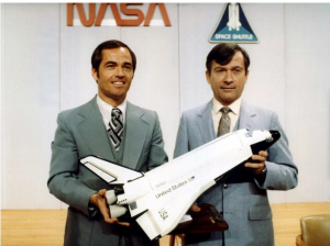 Crippen, left, and Young pose for photographers with a model of Space Shuttle Columbia following a press conference. Credit: NASA