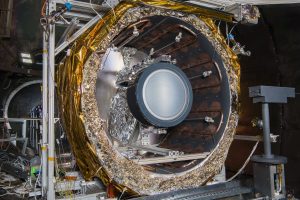 The NEXT-C flight thruster is mounted within a thermal shroud in one of NASA Glenn’s vacuum chambers. The thermal shroud subjects the thruster to the extreme thermal environments it has been designed to withstand. Credits: NASA/Bridget Caswell