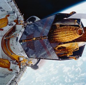 During STS-26, inertial upper stage (IUS) with tracking and data relay satellite C (TDRS-C) located in the payload bay (PLB) of Discovery, Orbiter Vehicle (OV) 103, is positioned into its proper deployment attitude (an angle of 50 degrees) by the airborne support equipment (ASE). Credit: NASA
