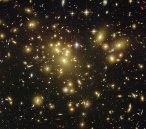 A massive cluster of yellowish galaxies is seemingly caught in a spider web of eerily distorted background galaxies in the left-hand image, taken with the Advanced Camera for Surveys ACS aboard NASA Hubble Space Telescope. Credit: NASA