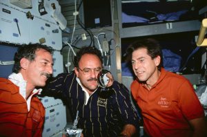 STS-35 crewmembers perform a microgravity experiment using their drinking water. Mission Specialist (MS) Jeffrey A. Hoffman (left) has released some water from a drinking container which he holds in his hand. MS John M. Lounge (wearing glasses, center) and Payload Specialist Samuel T. Durrance along with Hoffman study the changing shape and movement of the sphere of water. Credit: NASA