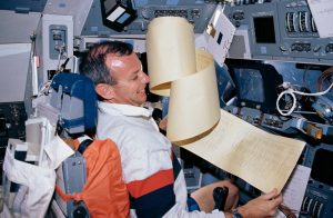 Brian Duffy, STS-45 pilot, struggles with a large volume of data printouts from the teleprinter system. Credit: NASA
