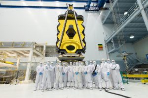Engineers and technicians in the cleanroom at NASA Goddard Space Flight Center, pose with the James Webb Space Telescope in the spring of 2017, before the telescope was transported to NASA’s Johnson Space Center for cryogenic testing.<br /> Credit: NASA/Desiree Stover