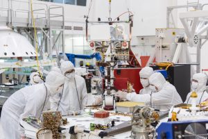 Engineers and technicians at NASA's Jet Propulsion Laboratory in Pasadena, California, install the remote sensing mast on the Mars 2020 rover. Credit: NASA/JPL-Caltech