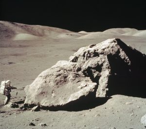Lunar Module pilot Harrison H. Schmitt collects rock samples from a huge boulder near the Moon's Taurus-Littrow Valley. Credit: NASA