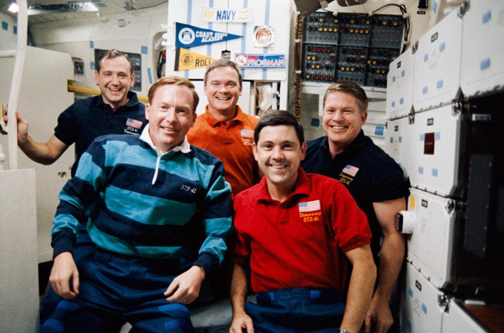 A 35mm preset camera on Discovery's middeck captures the traditional in-space portrait of the STS-41 crewmembers. In front are (l.-r.) Astronauts Richard N. Richards, mission commander; and Robert D. Cabana, pilot. In the rear are (l.-r.) Astronauts Thomas D. Akers, Bruce E. Melnick and William M. Shepherd. Credit: NASA