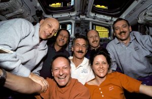With the Hubble Space Telescope (HST) berthed in Endeavour's cargo bay, crew members for the STS-61 mission pause for a crew portrait on the flight deck. Left to right are F. Story Musgrave, Richard O. Covey, Claude Nicollier, Jeffrey A. Hoffman, Kenneth D. Bowersox, Kathryn C. Thornton and Thomas D. Akers. Credit: NASA