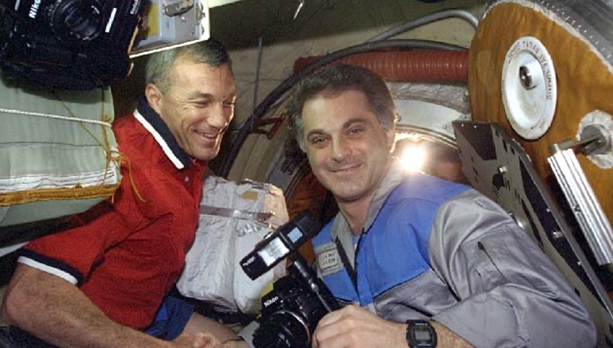 STS-89 Commander Terrence Wilcutt, left, greets Mission Specialist David Wolf at the airlock of Space Shuttle Endeavour, following Wolf’s 128-day mission aboard the Mir space station. It was a reunion in space for Wilcutt and Wolf, who were both from NASA Astronaut Group 13. Credit: NASA