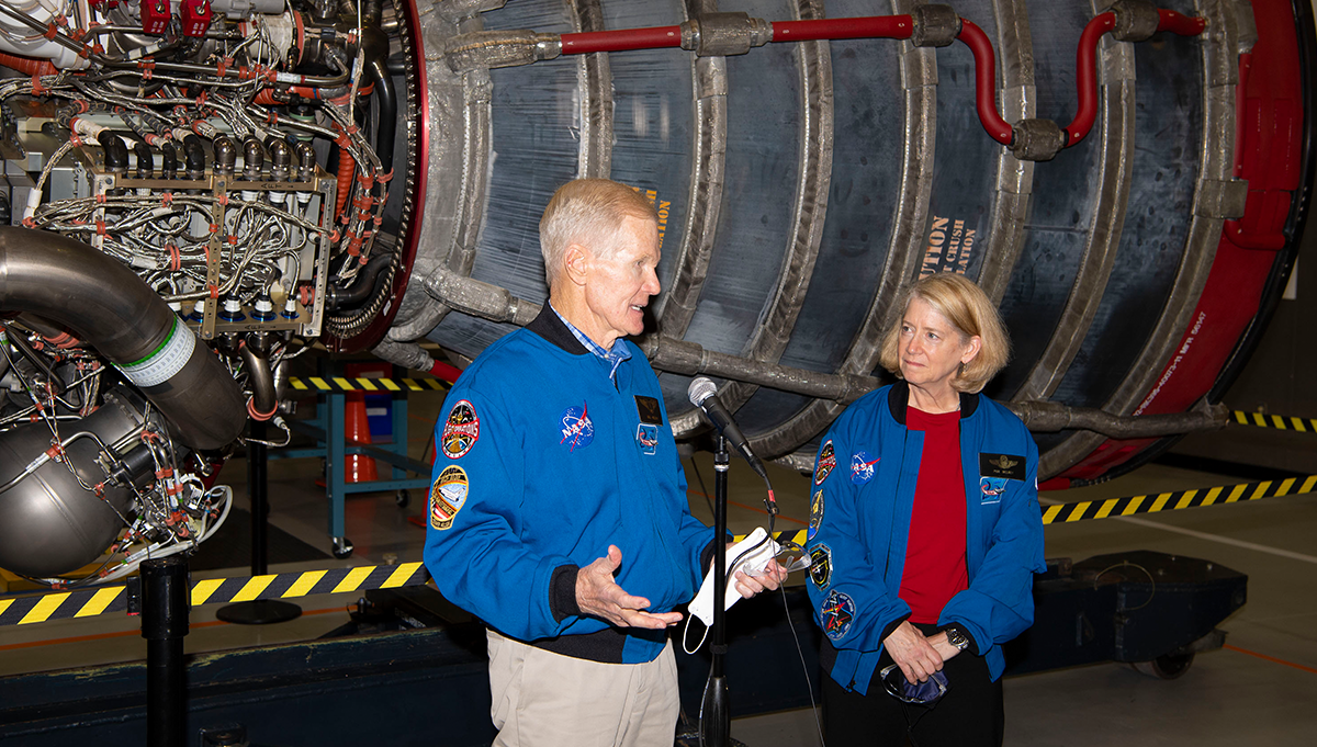 NASA Administrator Bill Nelson and NASA Deputy Administrator Pam Melroy speak with media during a visit to Stennis Space Center on Dec. 7, 2021, standing in front of an Aerojet Rocketdyne RS-25 engine like the ones that powered the Space Shuttle and now the Artemis program’s Space Launch System. Credit: NASA