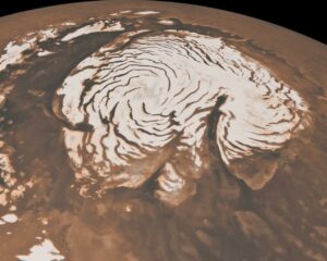 This image, combining data from two instruments aboard NASA's Mars Global Surveyor, depicts an orbital view of the north polar region of Mars. To the right of center, a large canyon, Chasma Boreale, almost bisects the white ice cap. Credit: NASA/JPL-Caltech/MSSS
