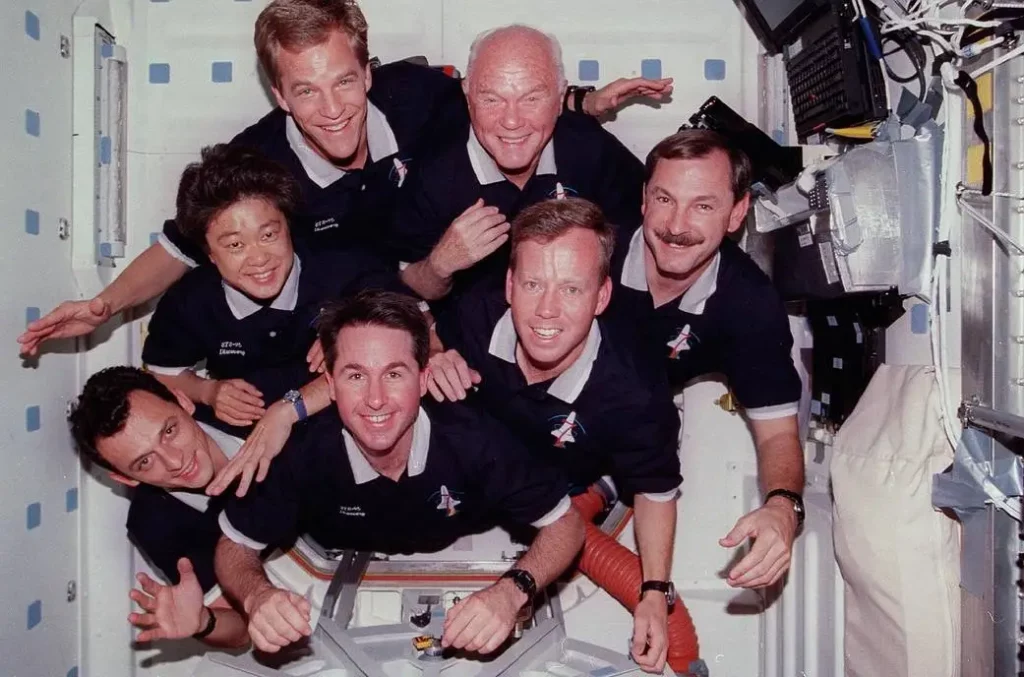 STS-95 crew portrait: Curtis L. Brown Jr., commander, appears at right center in the pyramid. Others, clockwise, are Steven W. Lindsey, pilot; Stephen K. Robinson, mission specialist; Pedro Duque, mission specialist (ESA), payload specialist Chiaki Naito-Mukai (NASDA); Scott E. Parazynski, mission specialist; and U.S. Senator John H. Glenn. Photo Credit: NASA