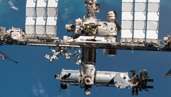 The International Space Station as seen from a SpaceX Crew Dragon capsule. In addition to the modules where astronauts live and work, several external structures are visible including the Alpha Magnetic Spectrometer seen on the far left. Photo Credit: NASA