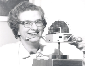 Dr. Nancy Grace Roman is shown with a model of the Orbiting Solar Observatory (OSO) in 1962. She was the first Chief of Astronomy in the Office of Space Science at NASA Headquarters and the first woman to hold an executive position at NASA. In her role, she had oversight for the planning and development of programs including the Cosmic Background Explorer and the Hubble Space Telescope. Photo Credit: NASA