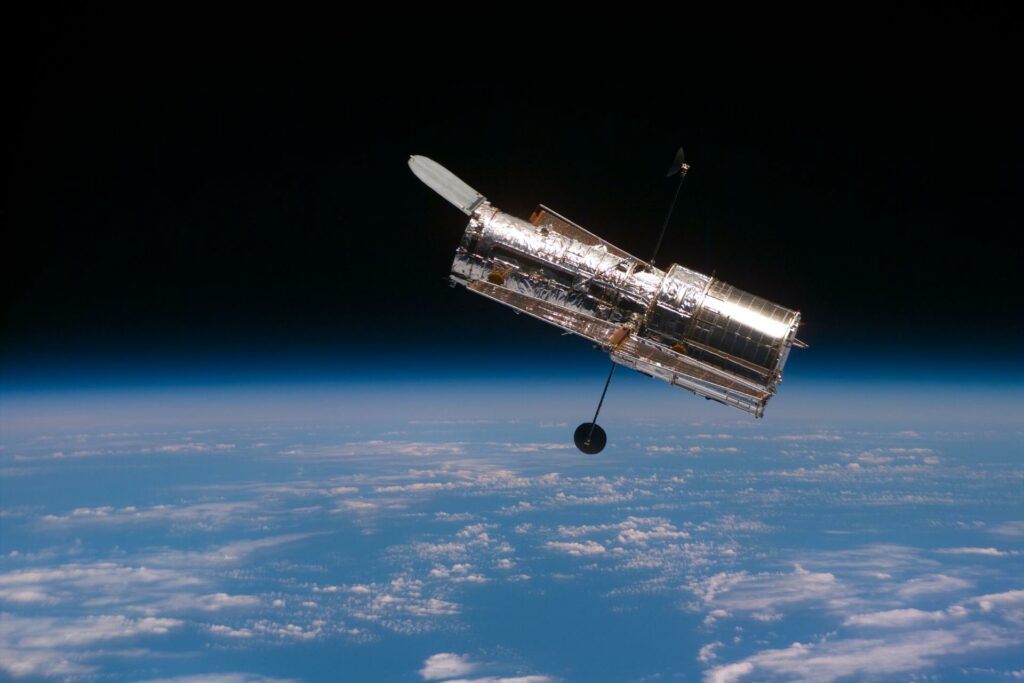 The Hubble Space Telescope (HST) begins its separation from the Space Shuttle Discovery following its release in 1997. This view was taken with an Electronic Still Camera (ESC). Photo Credit: NASA