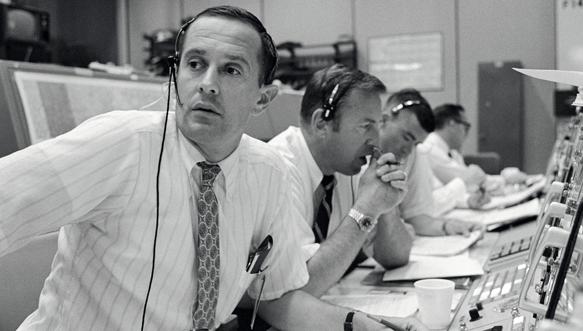 Apollo 11 CapCom Charles M. Duke, Jr., left, with astronauts James A. Lovell, Jr., center, and Fred W. Haise, Jr. during the first human lunar landing on July 20, 1969. Photo Credit: NASA