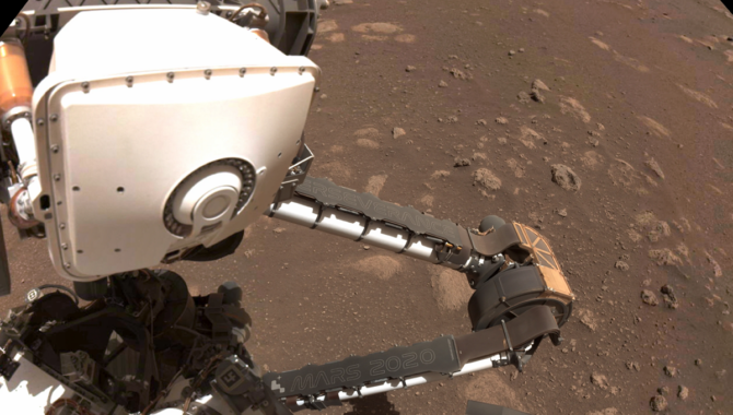 PIXL, the white instrument mounted on the robotic arm of NASA’s Perseverance Rover, uses a form of artificial intelligence known as adaptive sampling to examine rocks on the surface of Mars. Photo Credit: NASA