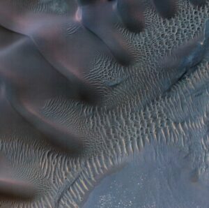 This enhanced-color image from NASA Mars Reconnaissance Orbiter shows sand dunes trapped in an impact crater in Noachis Terra, Mars. Credit: NASA/JPL-Caltech/Univ. of Arizona