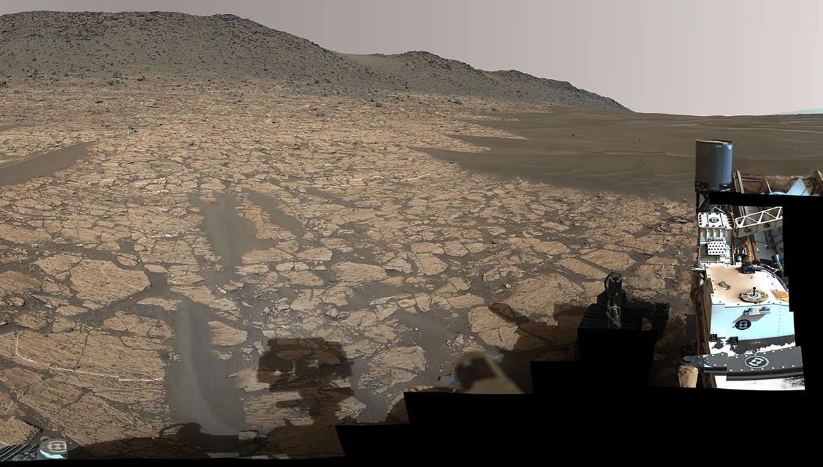 This view of a valley where water flowed billions of years ago was captured by NASA’s Perseverance rover using the Mastcam-Z instrument. A puzzling rock named “Cheyava Falls” is about 361 feet in front of the rover here and left of center. Credit: NASA