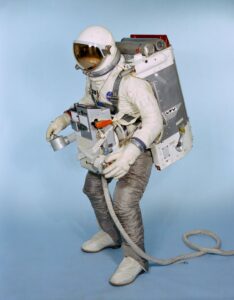 Test subject Fred Spross, Crew Systems Division, wears an Astronaut Maneuvering Unit (AMU). The Gemini spacesuit, AMU backpack, and the Extravehicular Life Support System chest pack comprises the AMU, a system which is essentially a miniature manned spacecraft. Credit: NASA