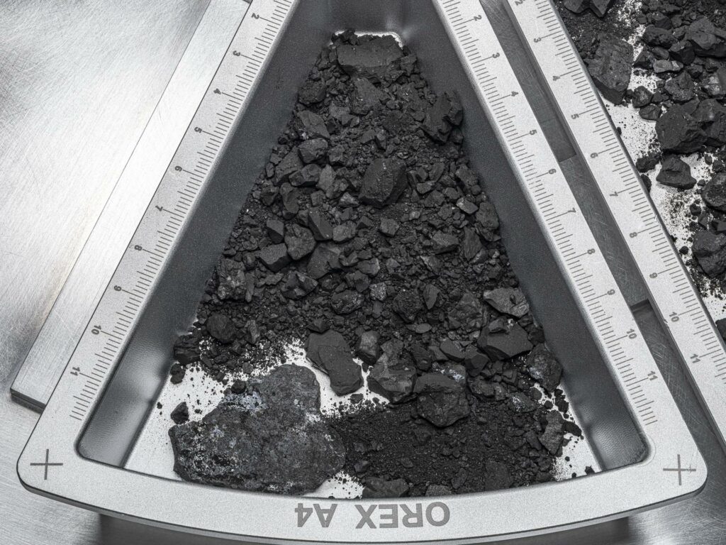 A top-down view of one of the containers holding rocks and dust from asteroid Bennu, with hardware scale marked in centimeters. Credit: NASA/Erika Blumenfeld and Joseph Aebersold