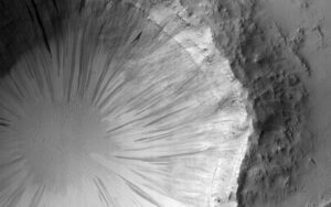 The steep walls of the crater are covered with slope streaks formed by material falling down towards the crater's center. Credit: NASA/JPL-Caltech/University of Arizona