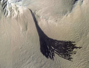 This image from NASA's Mars Reconnaissance Orbiter (MRO) shows streaks forming on slopes when dust cascades downhill. Credit: NASA