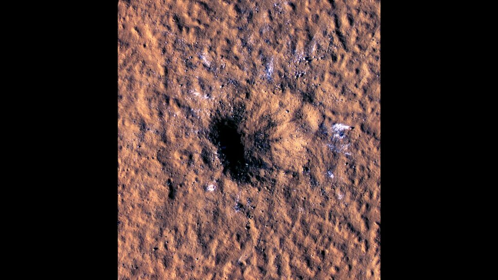 Boulder-size blocks of water ice can be seen around the rim of this giant meteoroid impact crater on Mars, as viewed by the High-Resolution Imaging Science Experiment (HiRISE camera) aboard NASA's Mars Reconnaissance Orbiter. Credit: NASA/JPL-Caltech/University of Arizona