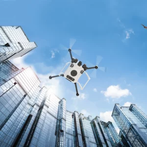 Illustration of a drone as viewed from below. The drone is either landing or taking off between skyscrapers. Another drone flies above it. Credit: NASA